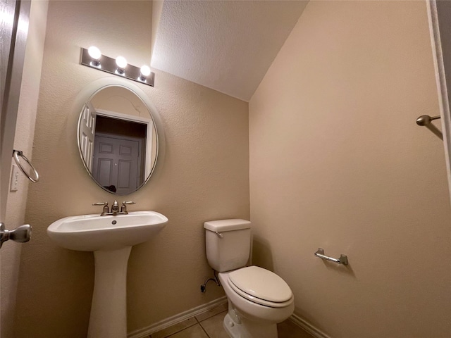 4133 Kyndra Cir, Richardson, TX 75082 - half bath featuring tile patterned floors, toilet, lofted ceiling, and a sink