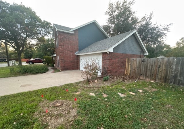 view of side of property with a garage and a yard