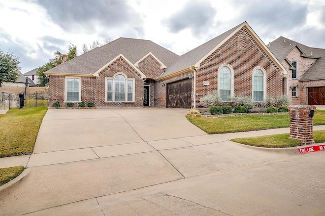 view of front of property featuring a garage and a front lawn