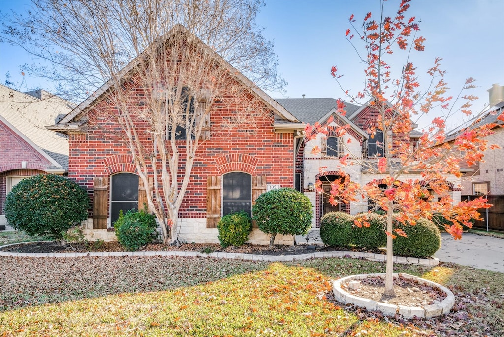 tudor home featuring a front yard