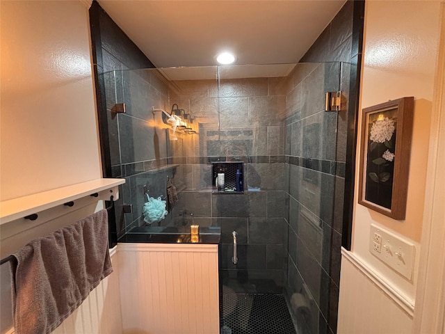 bathroom with a shower with door