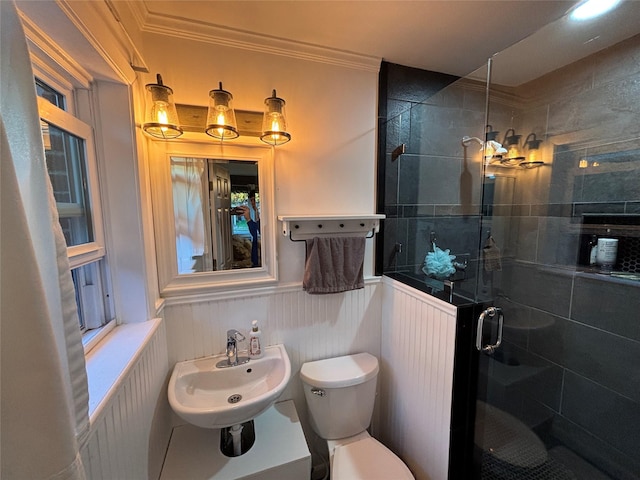 bathroom featuring toilet, an enclosed shower, ornamental molding, and sink