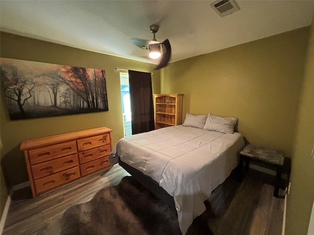 bedroom with ceiling fan and dark wood-type flooring