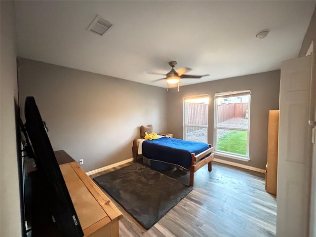 bedroom with hardwood / wood-style floors, ceiling fan, and billiards