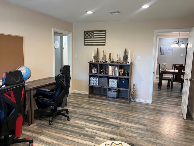 office featuring a chandelier and dark wood-type flooring