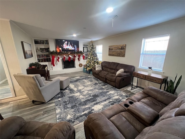 living room with wood-type flooring and ornamental molding