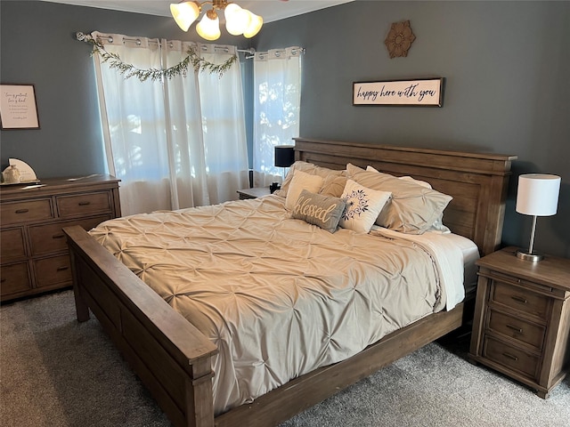 carpeted bedroom featuring a chandelier