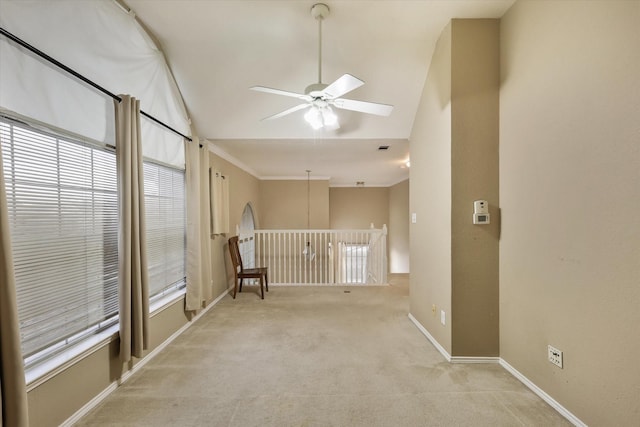 carpeted empty room with lofted ceiling and ceiling fan