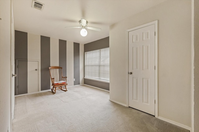 unfurnished room featuring light carpet and ceiling fan