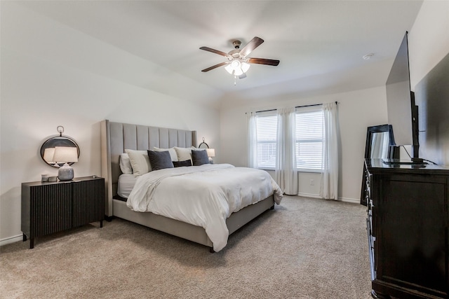 bedroom featuring ceiling fan, light colored carpet, and vaulted ceiling