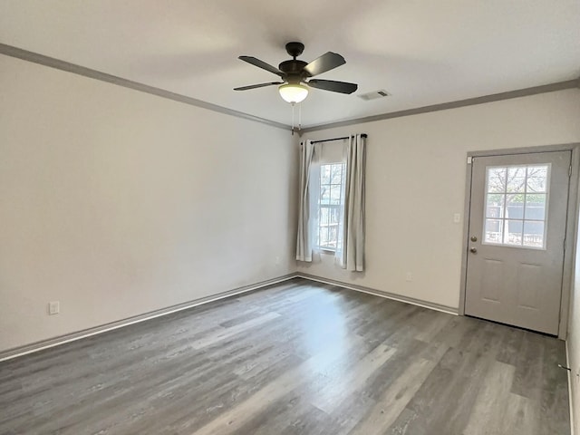 empty room with ceiling fan, ornamental molding, and light hardwood / wood-style floors