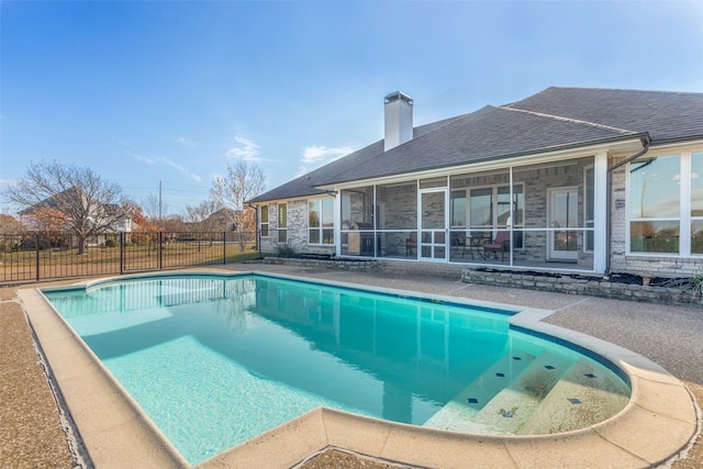 view of swimming pool featuring a sunroom