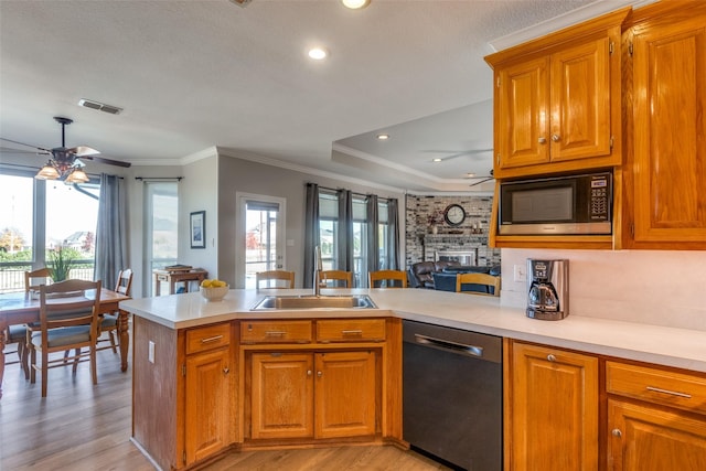 kitchen with built in microwave, sink, stainless steel dishwasher, kitchen peninsula, and crown molding