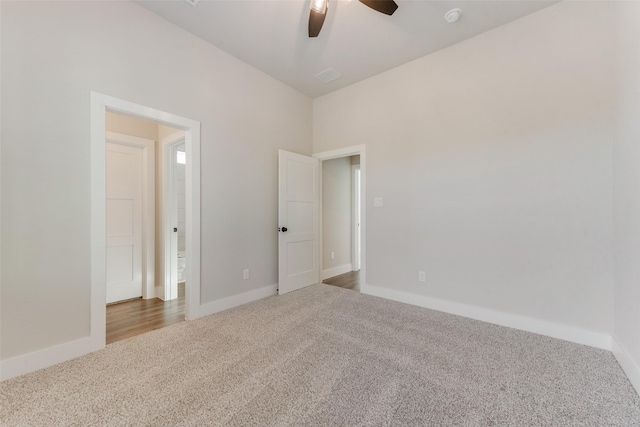 spare room featuring ceiling fan and carpet floors