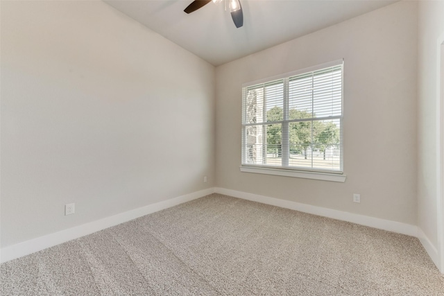 carpeted spare room featuring vaulted ceiling and ceiling fan