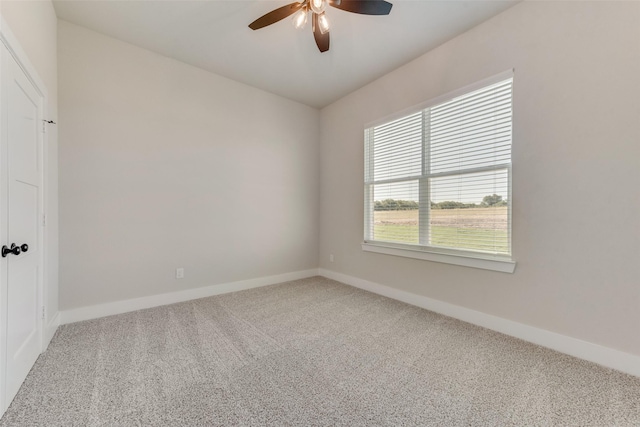 empty room featuring carpet flooring and ceiling fan