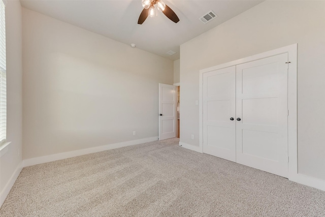 unfurnished bedroom featuring ceiling fan, carpet floors, and a closet