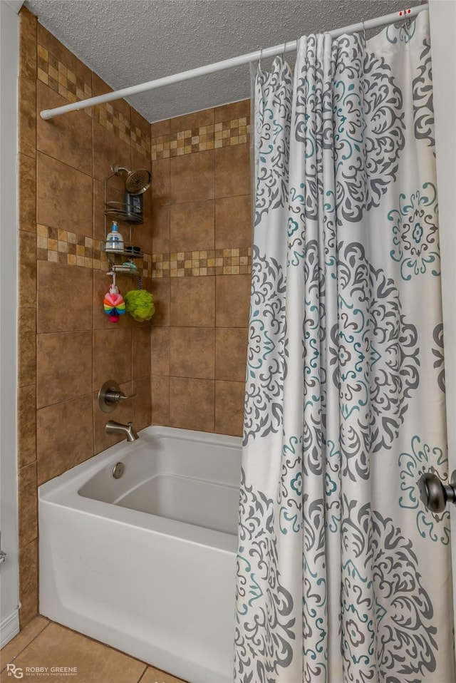 bathroom featuring tile patterned flooring, shower / bath combination with curtain, and a textured ceiling