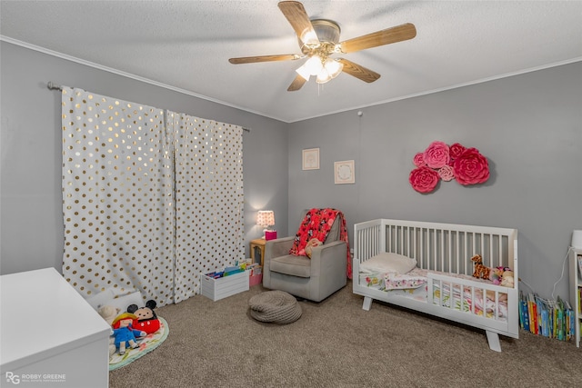 carpeted bedroom with ornamental molding, a nursery area, and a textured ceiling