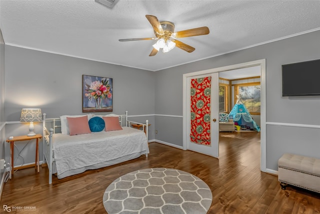 bedroom with crown molding, ceiling fan, hardwood / wood-style flooring, and a textured ceiling