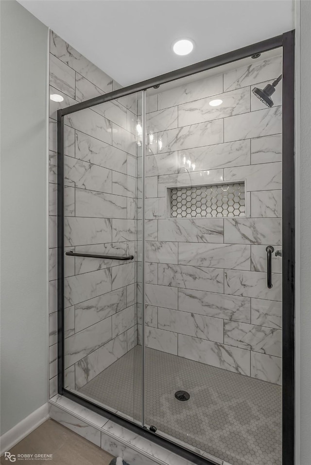 bathroom with a shower with shower door