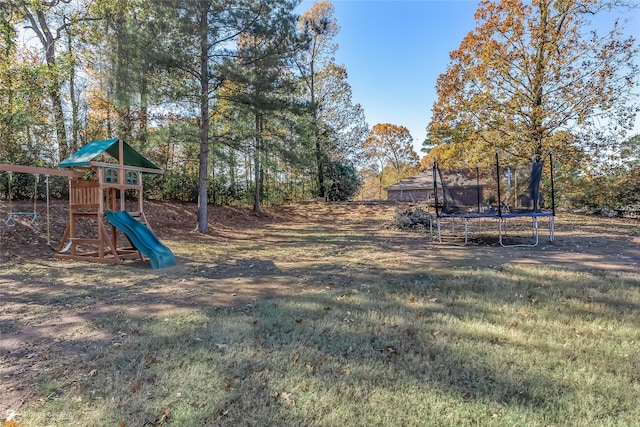 view of yard featuring a trampoline and a playground