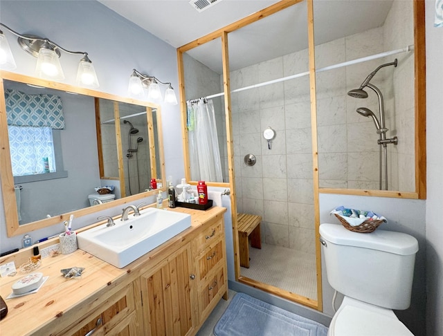 full bath with a shower stall, toilet, and vanity