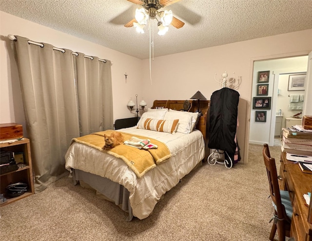 carpeted bedroom with ceiling fan and a textured ceiling