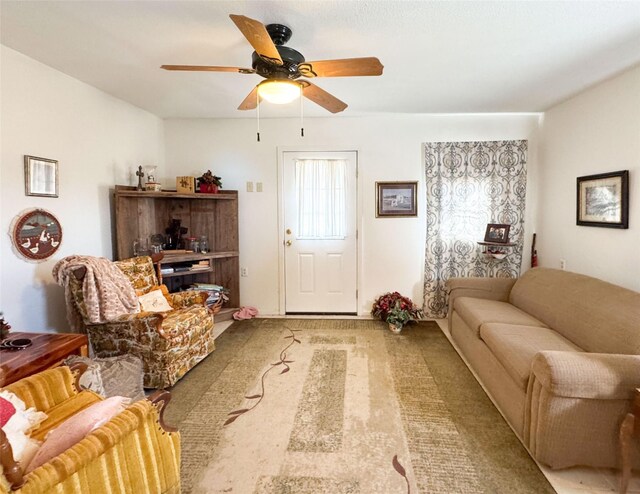 living room with ceiling fan and light colored carpet