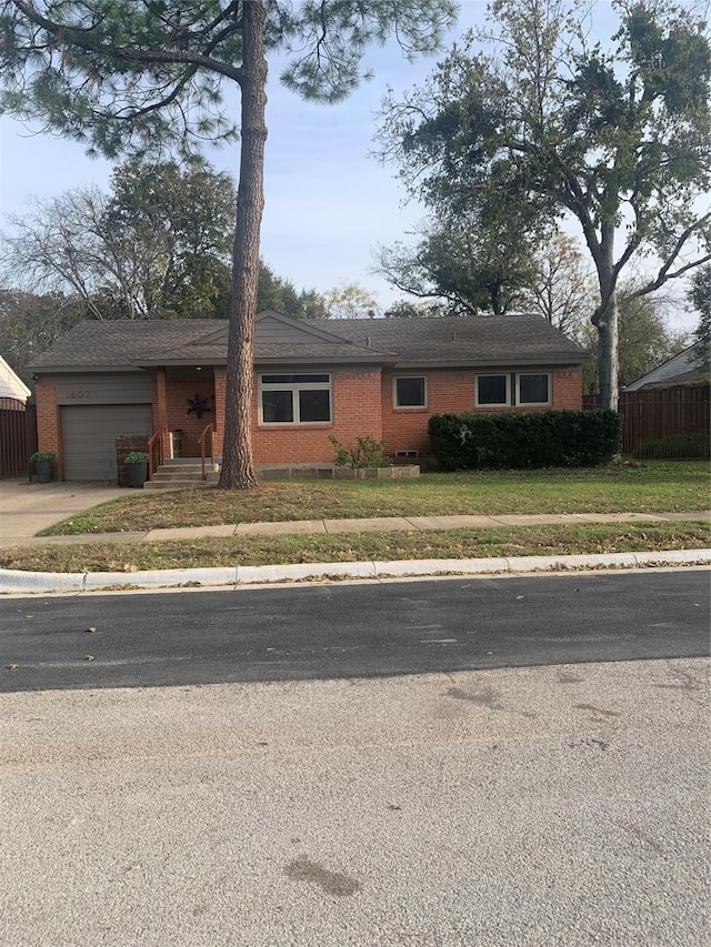 ranch-style house with a front lawn and a garage