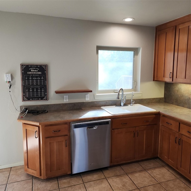 kitchen featuring stainless steel dishwasher, light tile patterned floors, decorative backsplash, and sink