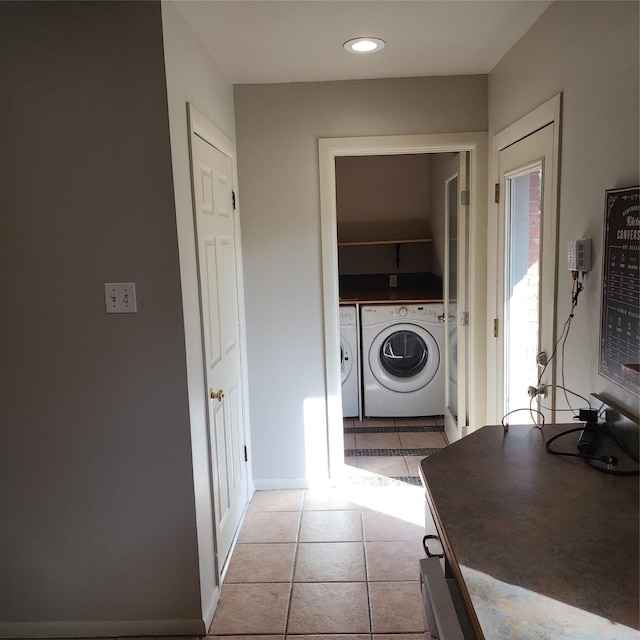 washroom featuring washing machine and dryer and light tile patterned flooring