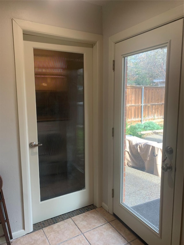 doorway to outside featuring light tile patterned floors