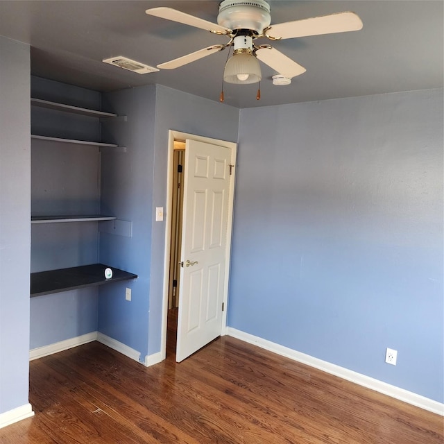 interior space with ceiling fan, a closet, and dark hardwood / wood-style floors