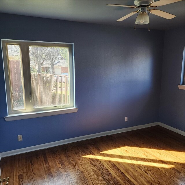 empty room featuring ceiling fan and hardwood / wood-style floors