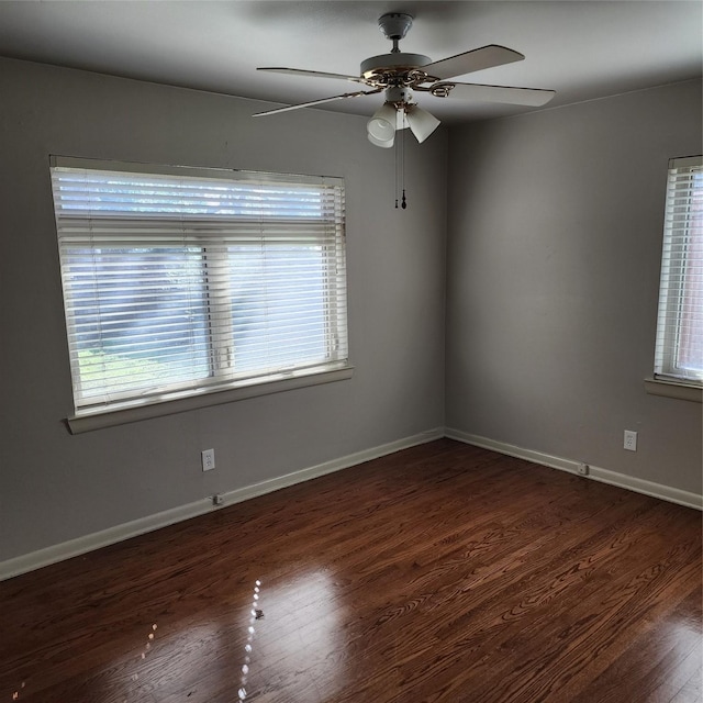 unfurnished room featuring dark wood-type flooring and ceiling fan