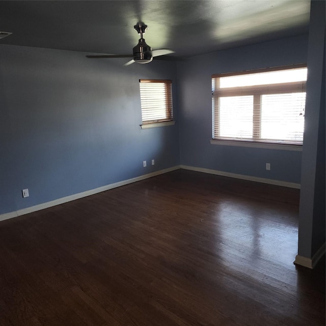 unfurnished room featuring ceiling fan and dark hardwood / wood-style floors