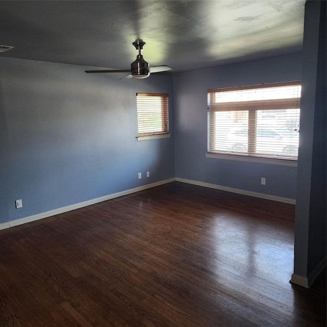 unfurnished room with ceiling fan and dark hardwood / wood-style flooring