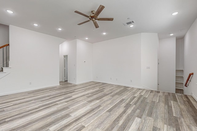 unfurnished living room with light hardwood / wood-style flooring and ceiling fan