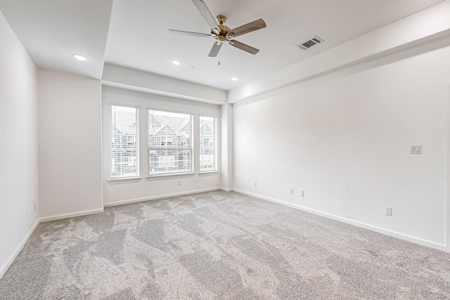 empty room featuring ceiling fan and light colored carpet