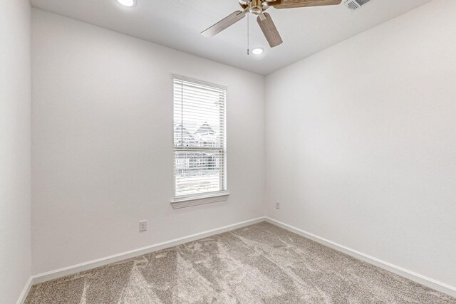 unfurnished room featuring ceiling fan and carpet