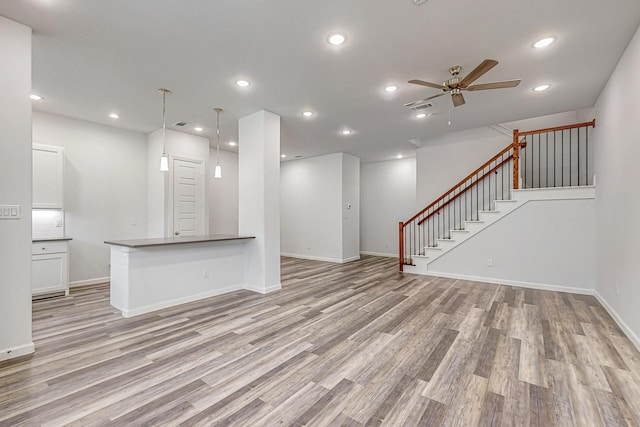 unfurnished living room with ceiling fan and light hardwood / wood-style floors