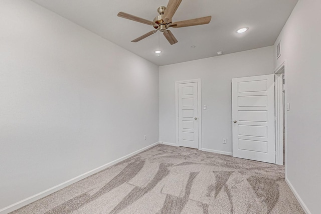 unfurnished bedroom featuring light carpet and ceiling fan