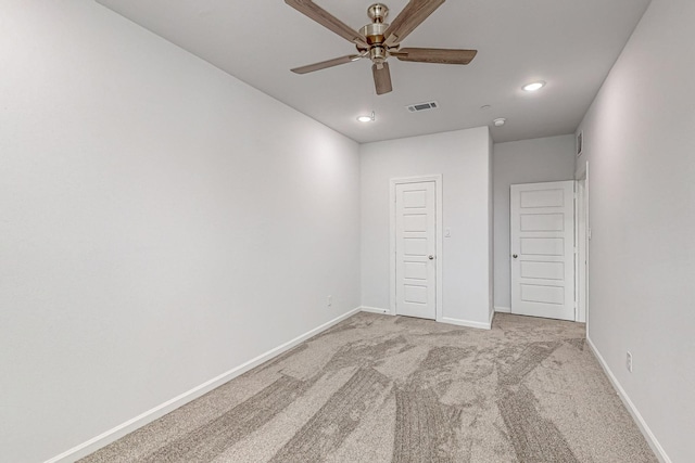 unfurnished bedroom featuring ceiling fan and light carpet