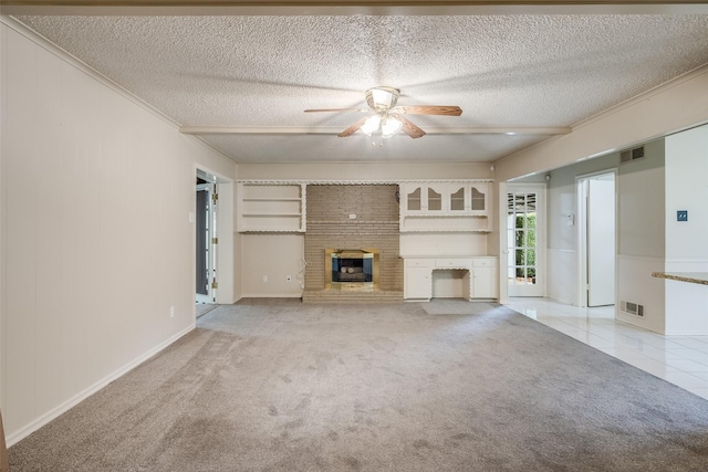 unfurnished living room with a textured ceiling, ceiling fan, light colored carpet, and a fireplace