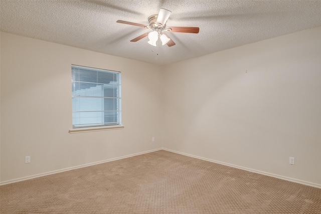 carpeted spare room featuring ceiling fan and a textured ceiling