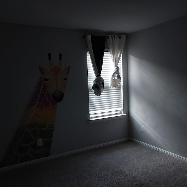 unfurnished room featuring dark colored carpet