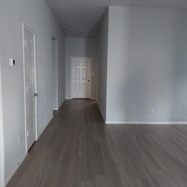 corridor featuring dark wood-type flooring