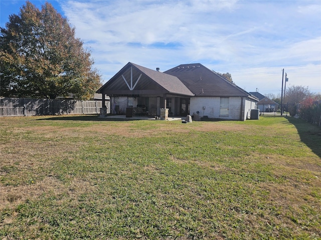 back of property featuring a yard and a patio