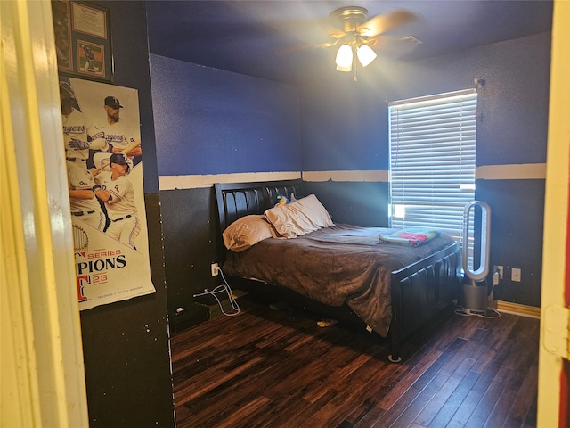 bedroom with ceiling fan and dark wood-type flooring